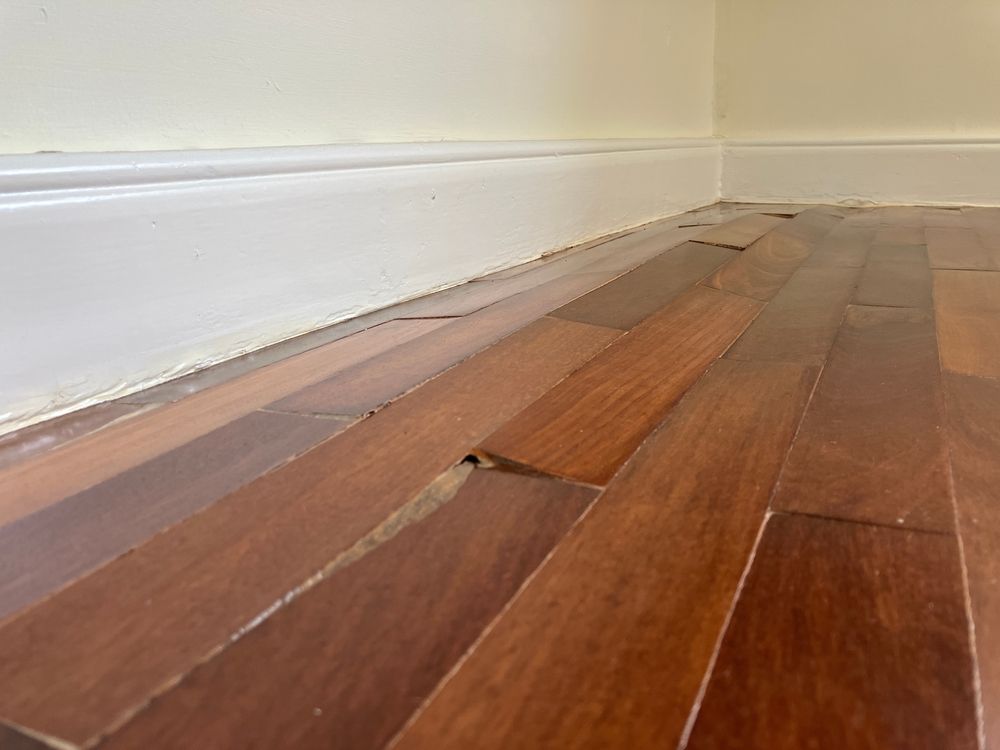 A close up of a wooden floor in a room.