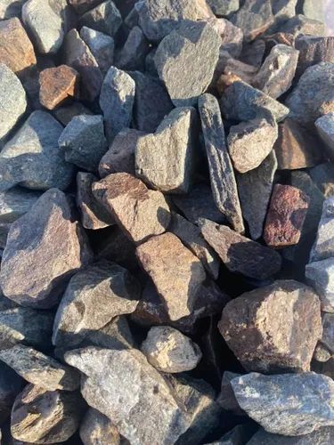 Pile of assorted rocks, ranging in color from gray to brown.