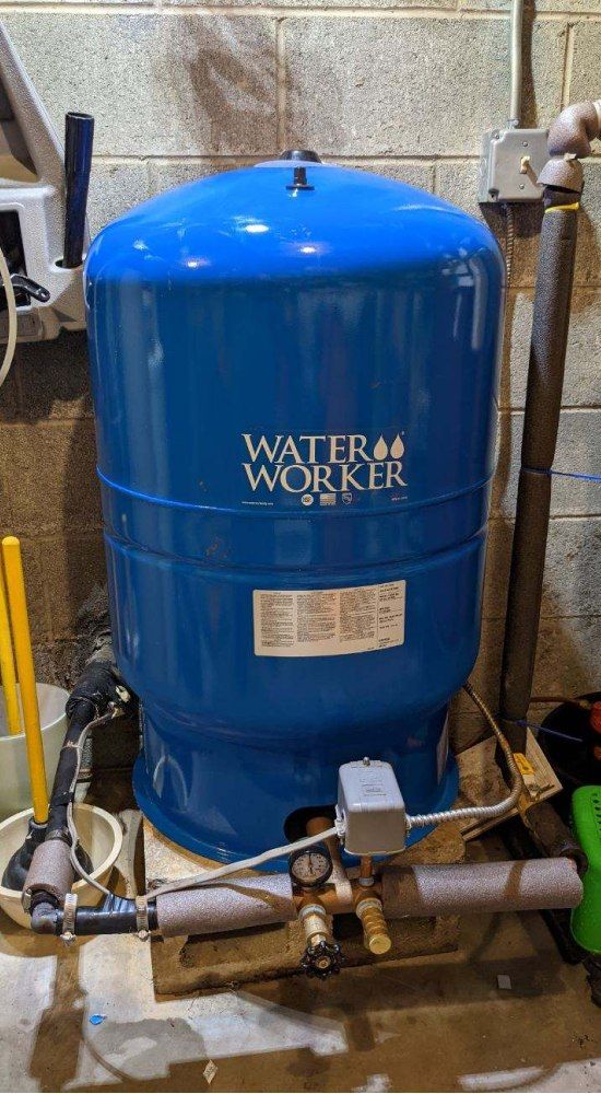 Blue Water Worker pressure tank in a basement setting.