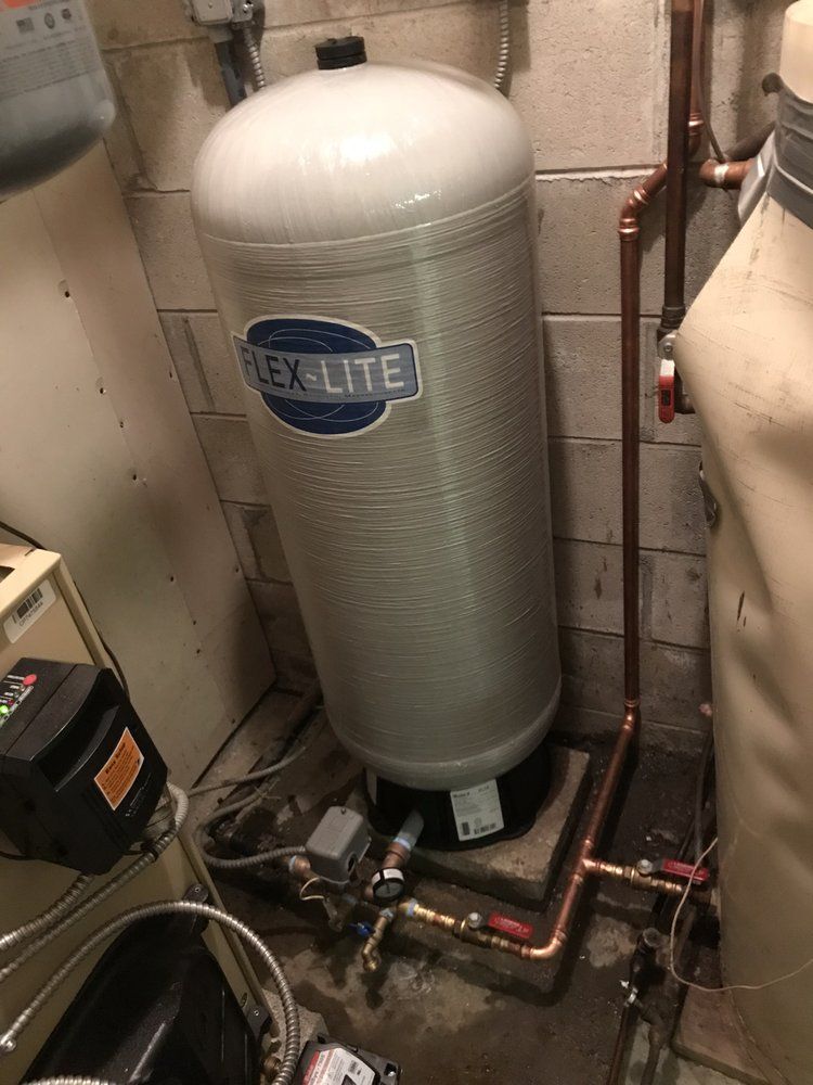 Tall, cylindrical water pressure tank labeled 