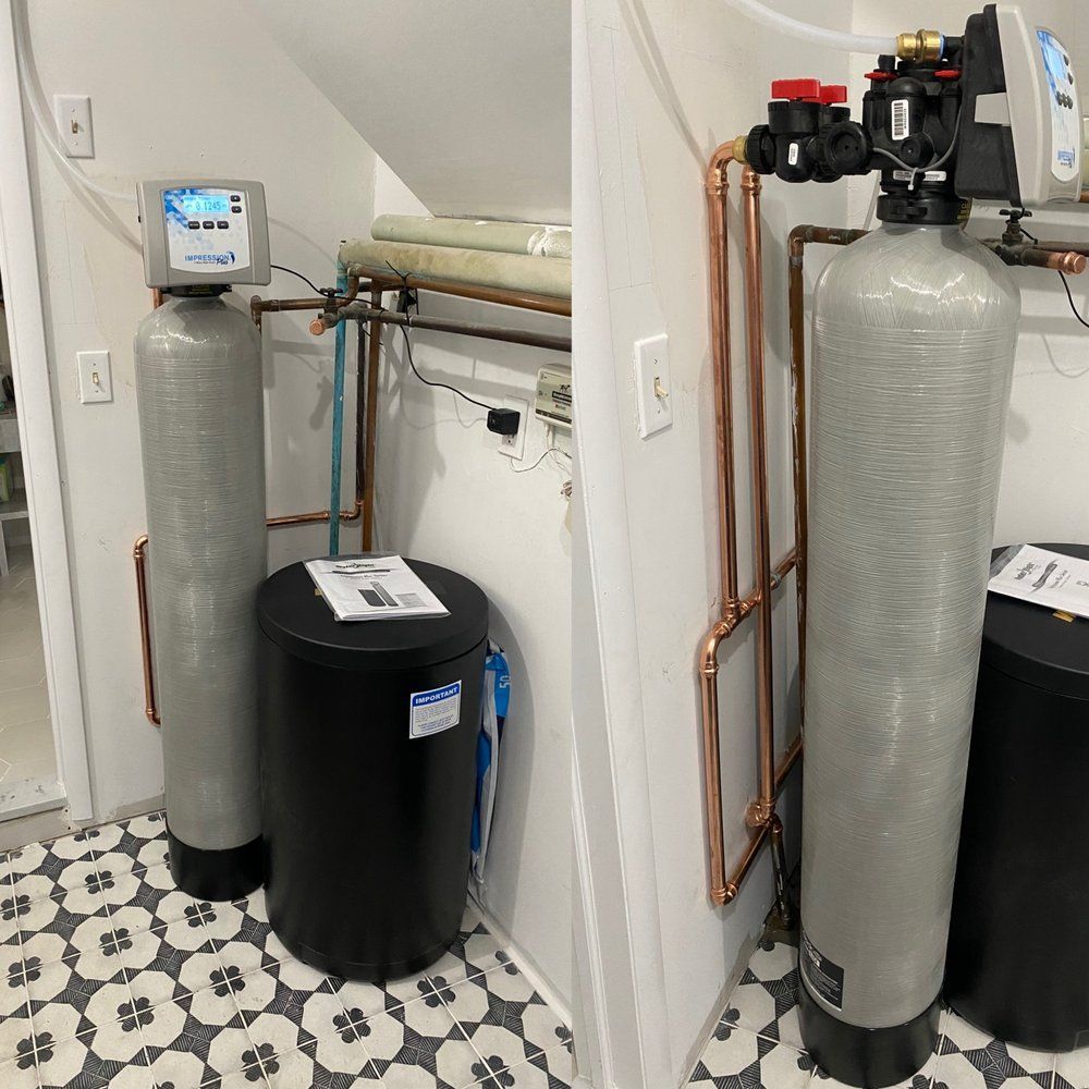 Two water filtration systems in a utility room with copper pipes and a patterned floor.