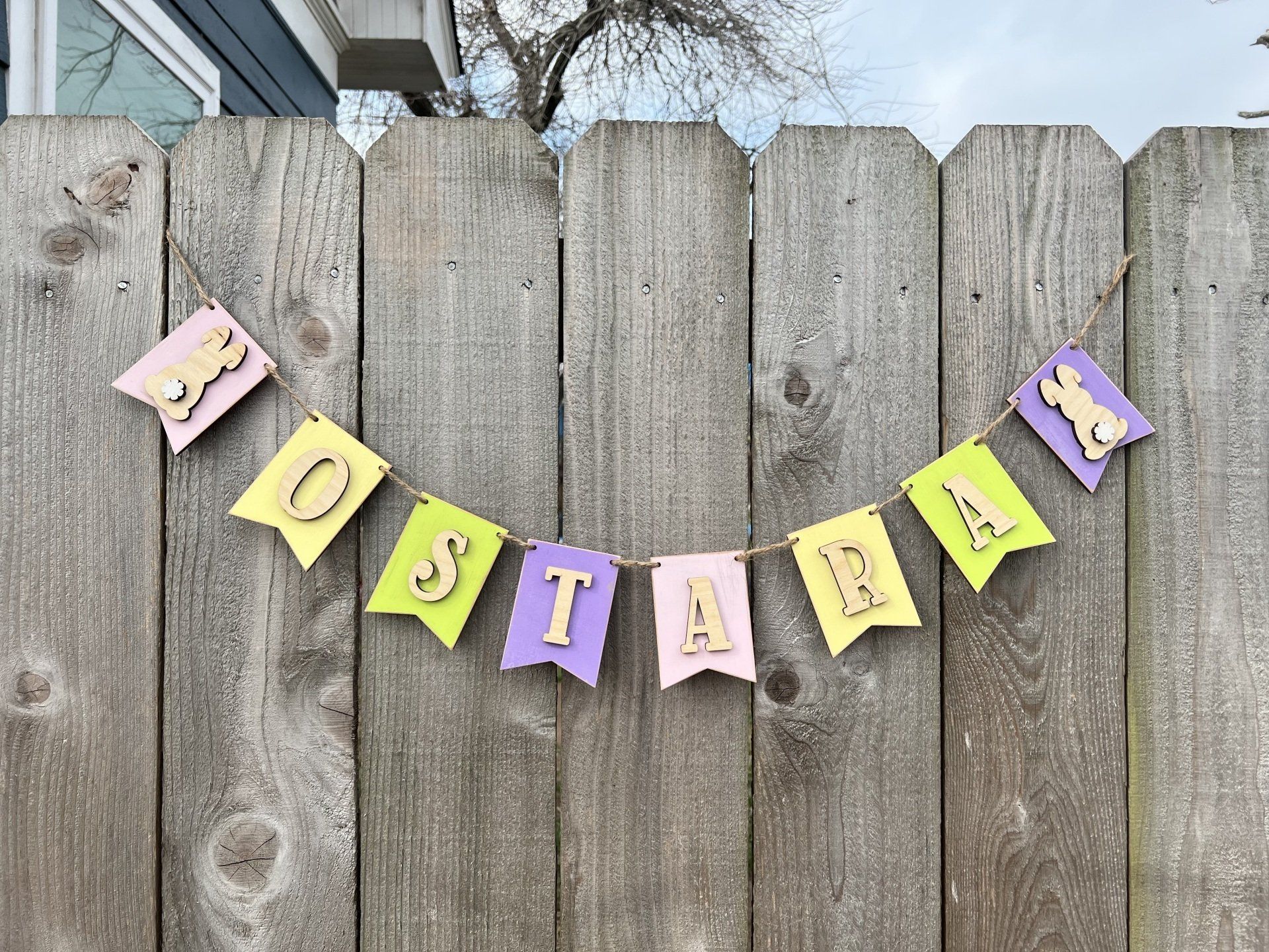 A wooden fence with a banner hanging from it.