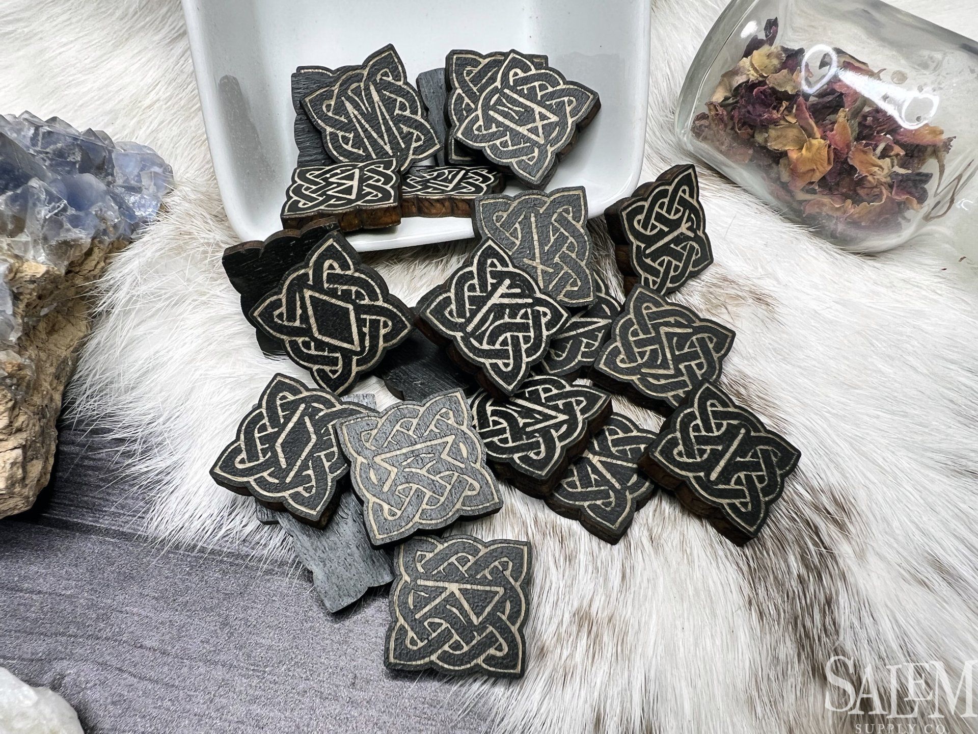 A bunch of celtic knots are sitting on top of each other on a table.