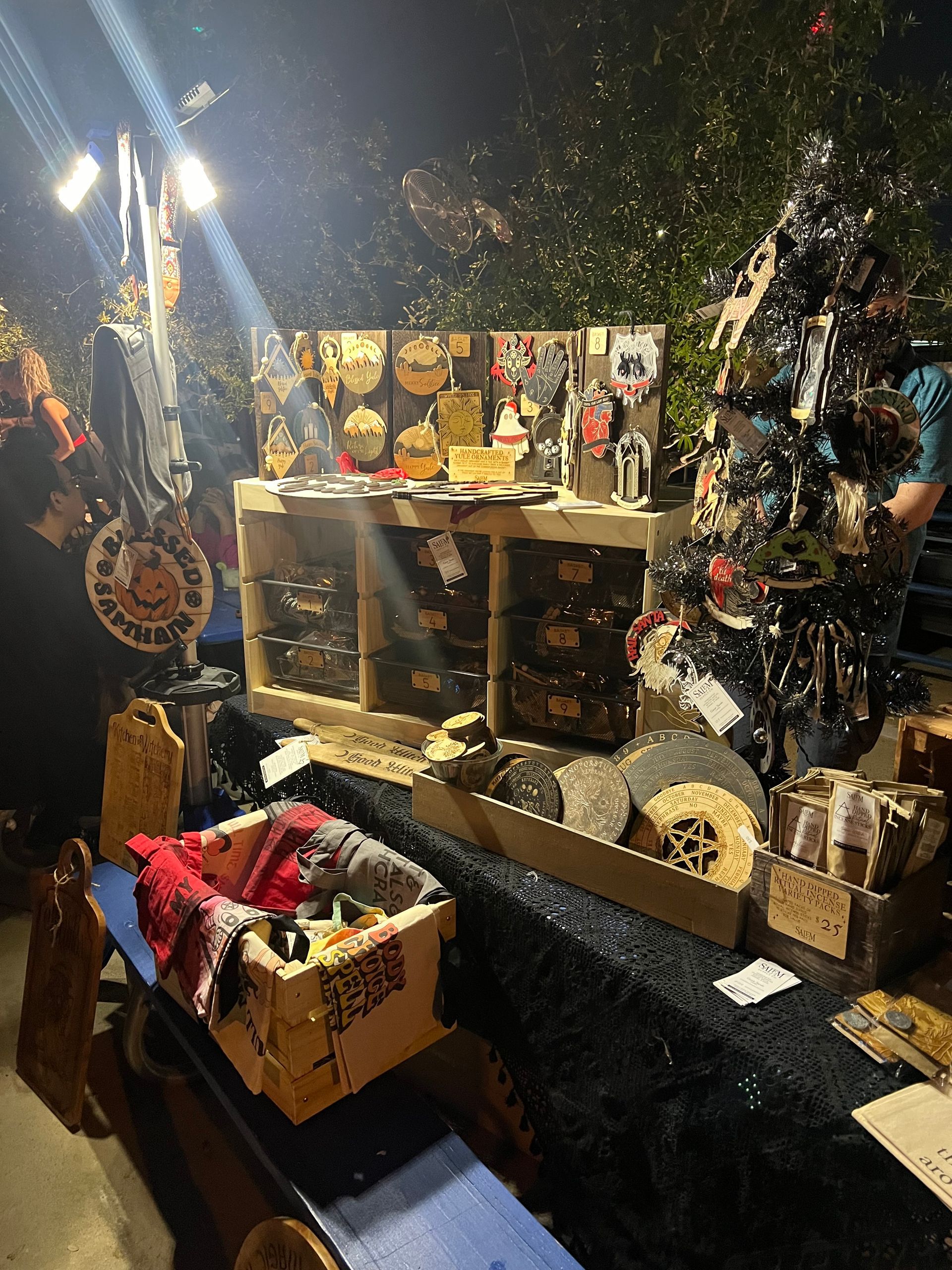 A christmas tree is sitting on top of a table at a market.