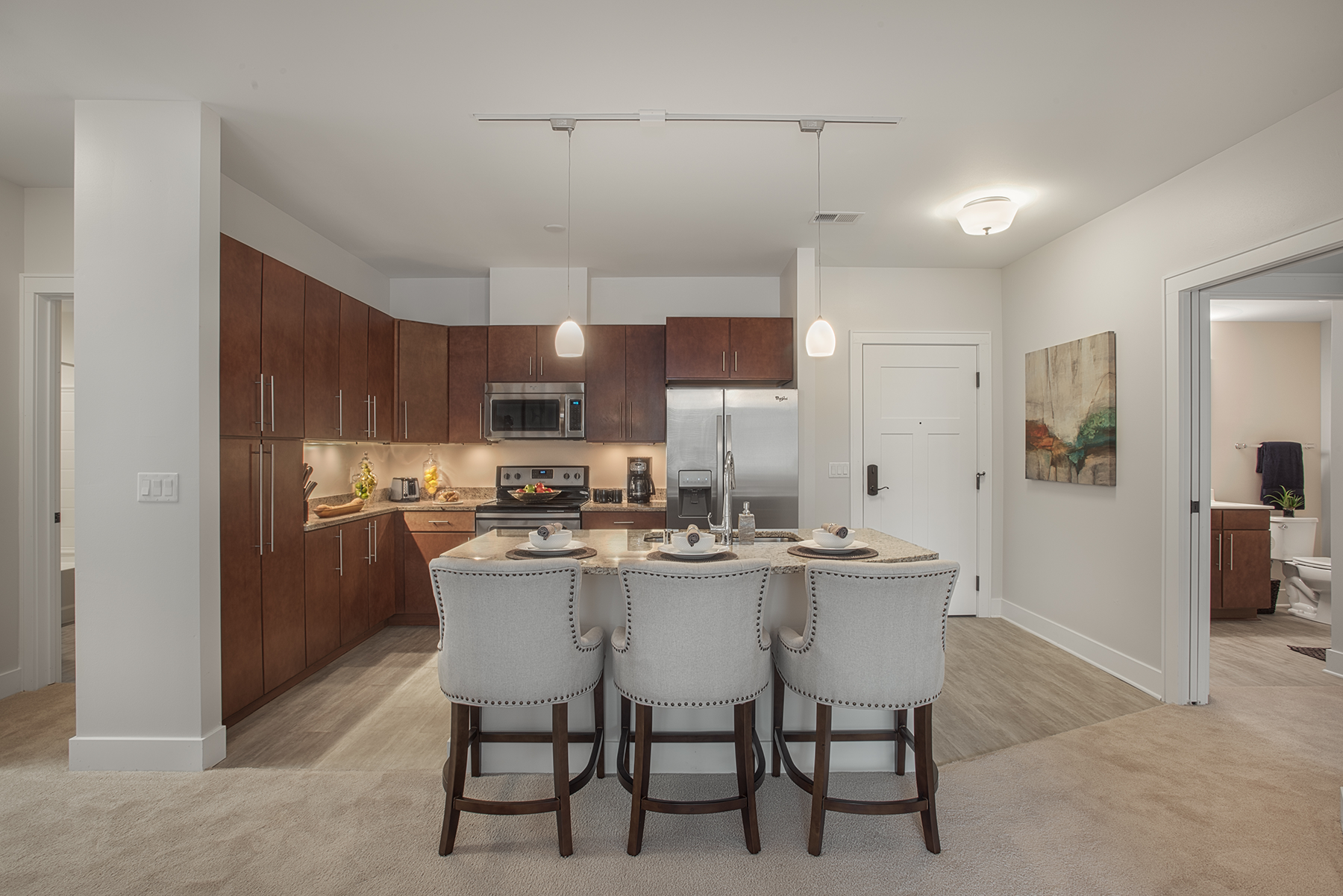 A kitchen with a dining table and chairs in it