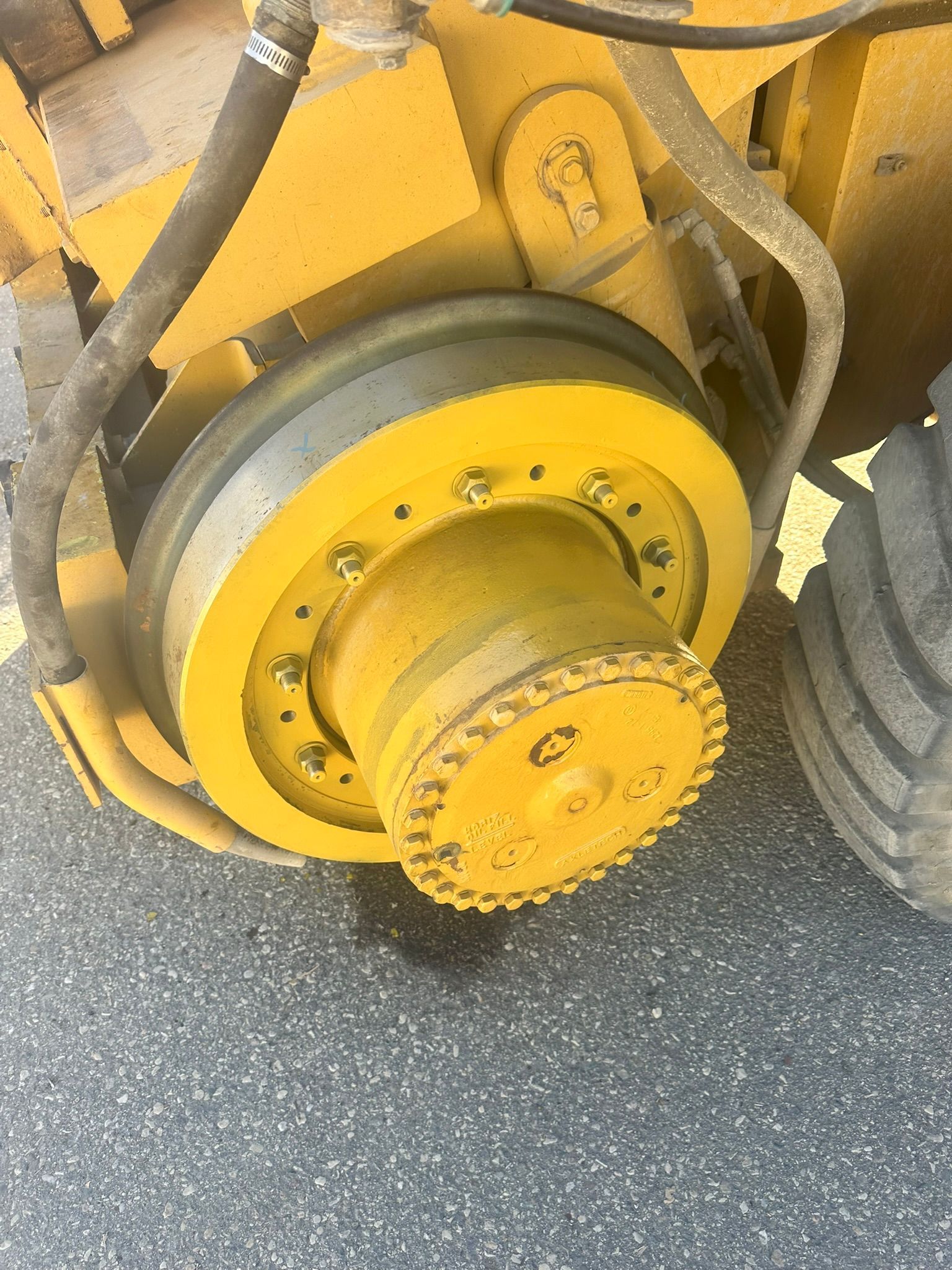 Yellow wheel hub on heavy machinery.