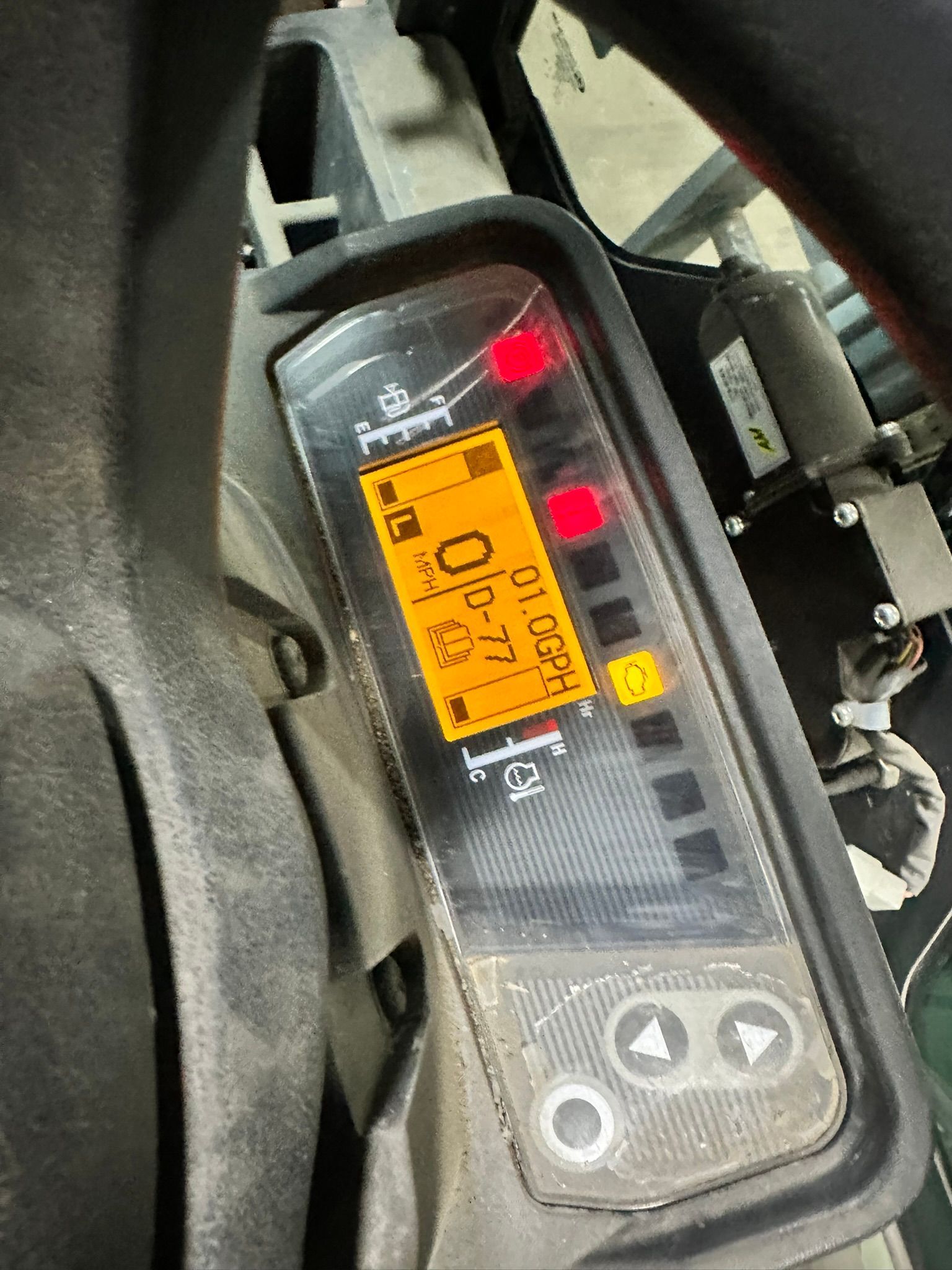 Dashboard display with orange digital numbers and various indicator lights lit.