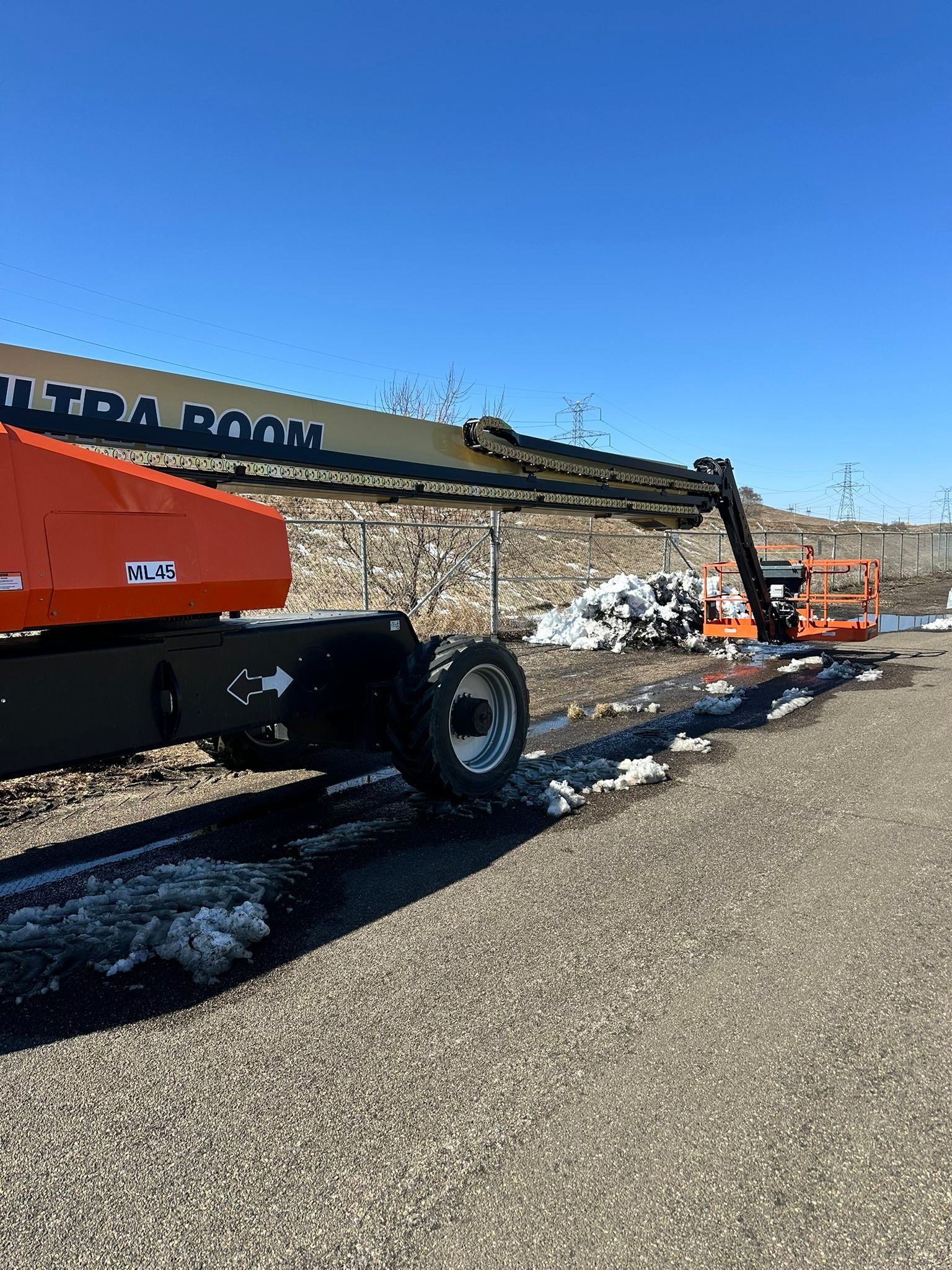 Orange aerial lift near a building with 