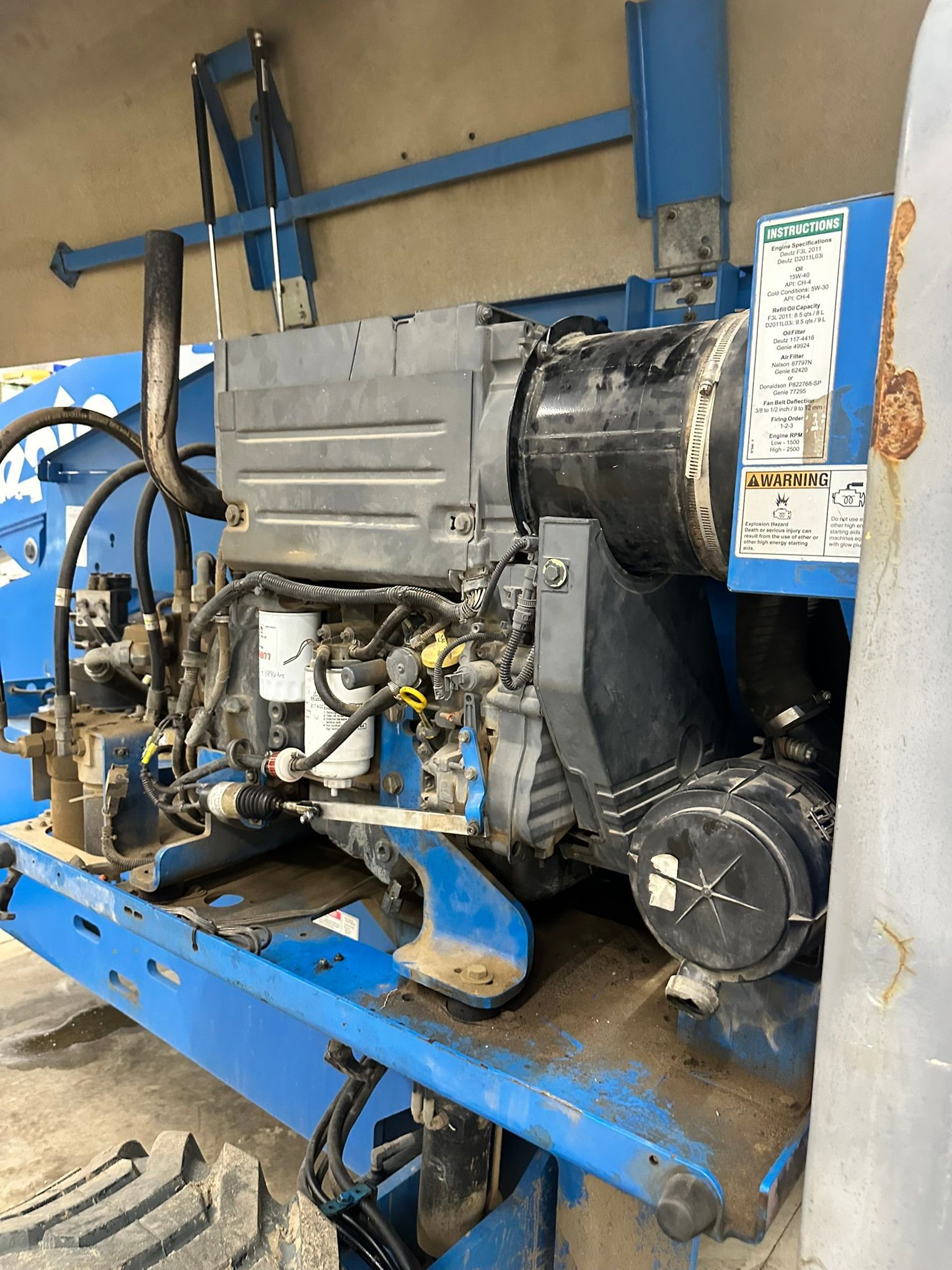 Blue Genie lift machinery with visible engine components.