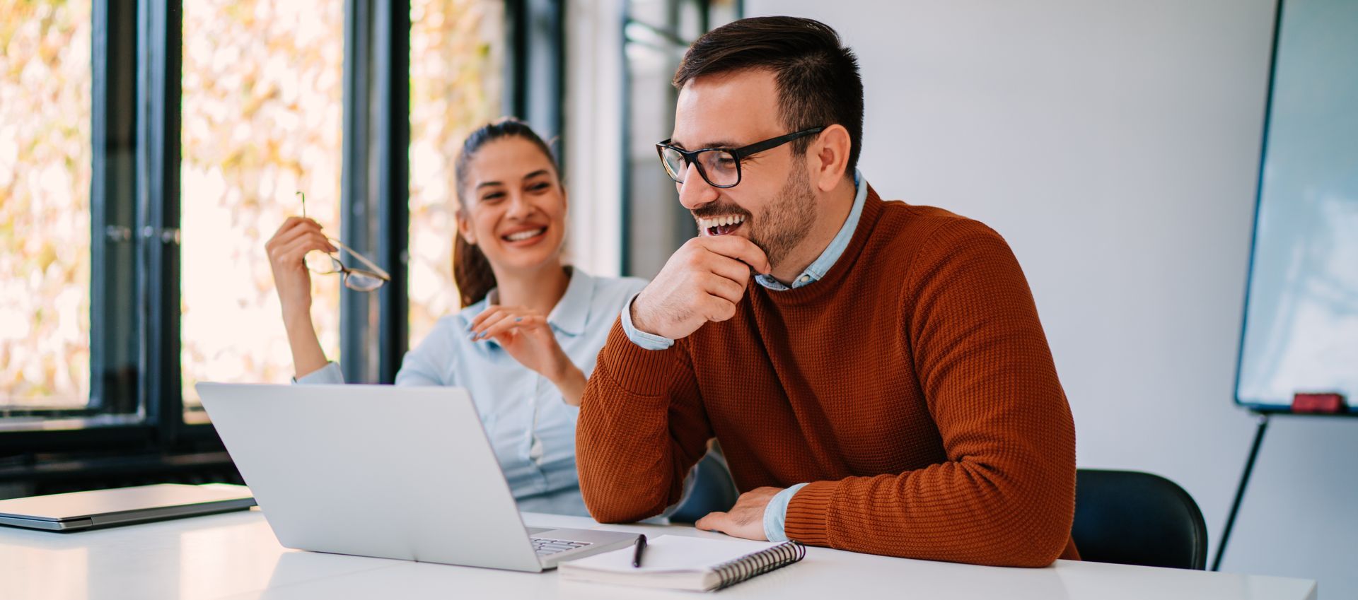 Male college counselor advising a female student