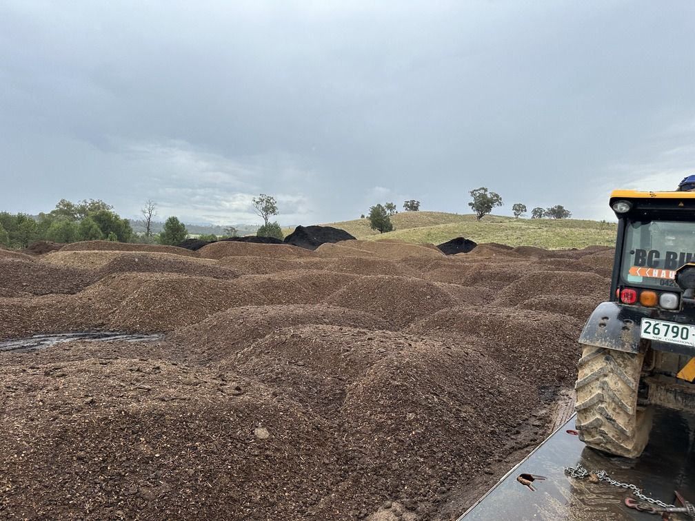 A Person Levelling The Large Dirt Field — BC Bulk Haulage In Tamworth, NSW