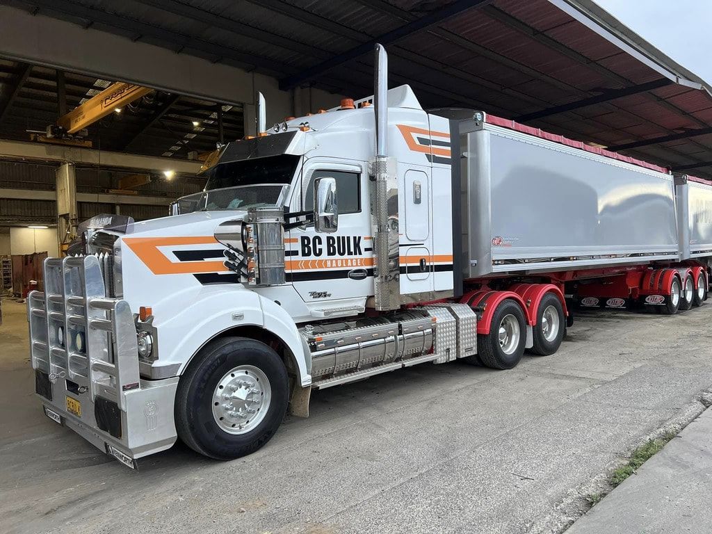 Pile Of Sand On A Dirt Field In Front Of Shed — BC Bulk Haulage In Tamworth, NSW