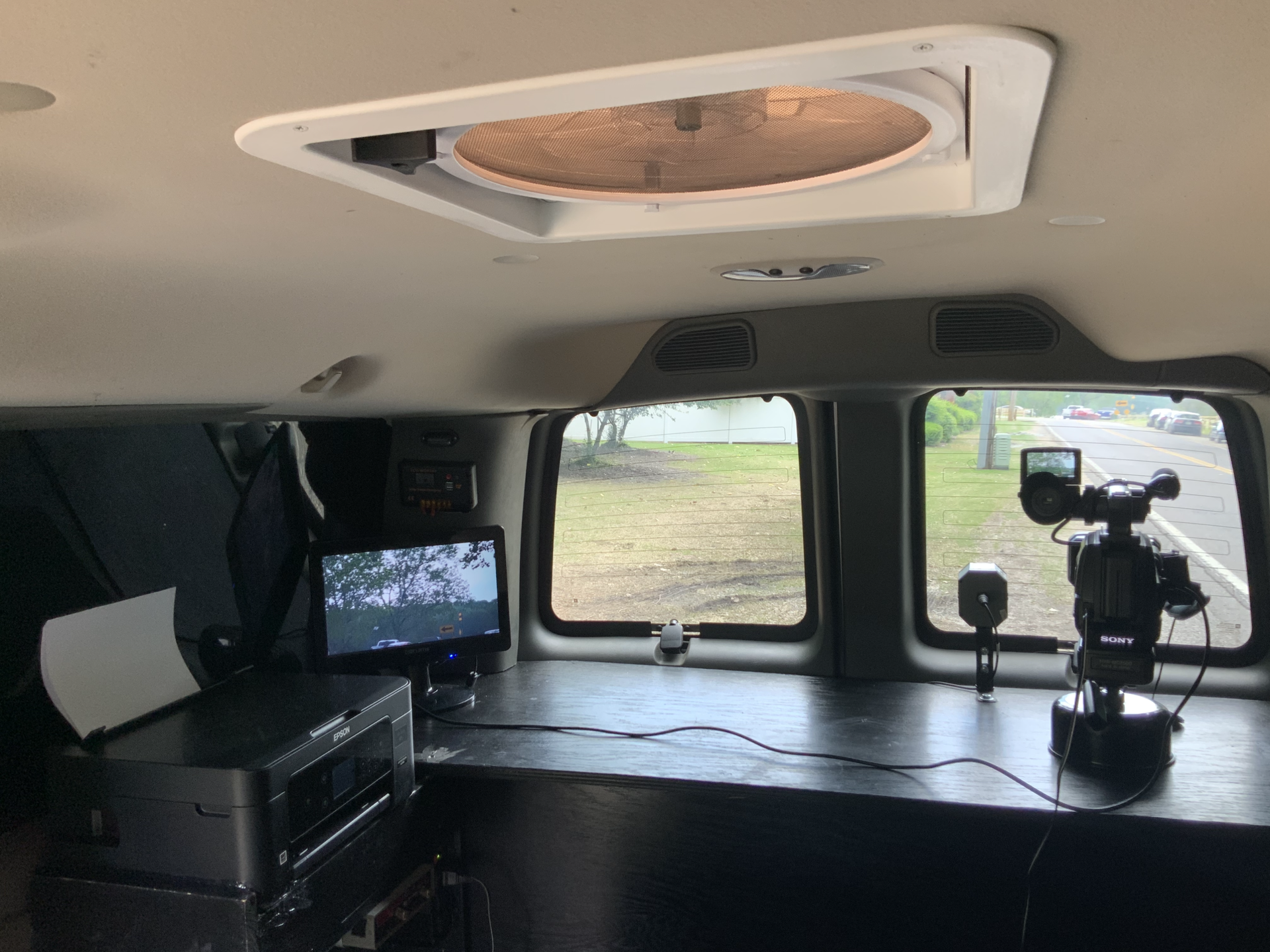 A camera is sitting on a table in the back of a van.