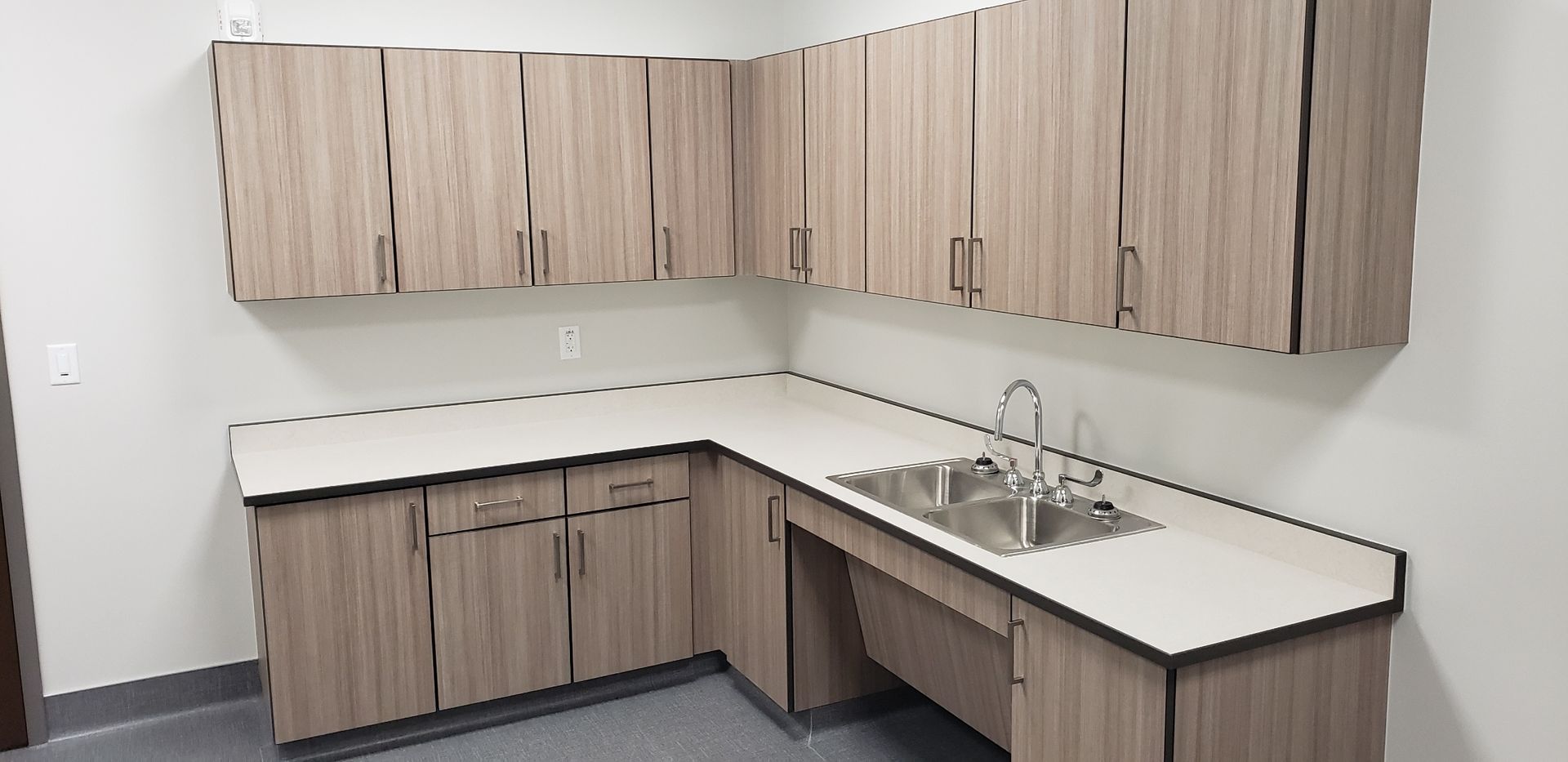 A kitchen with wooden cabinets and a sink.