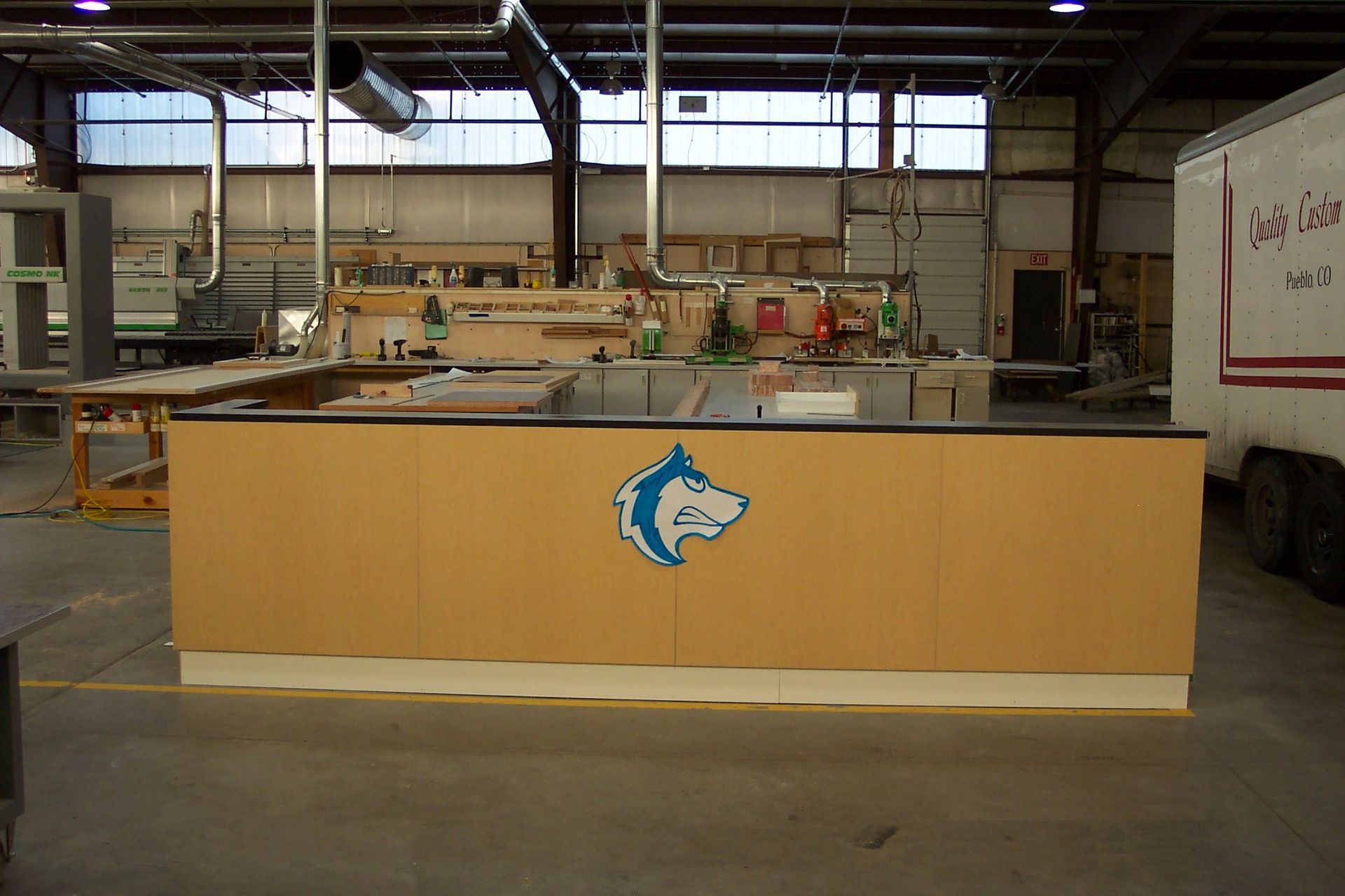 A large wooden counter with a horse logo on it