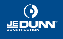 A blue and white logo for je dunn construction