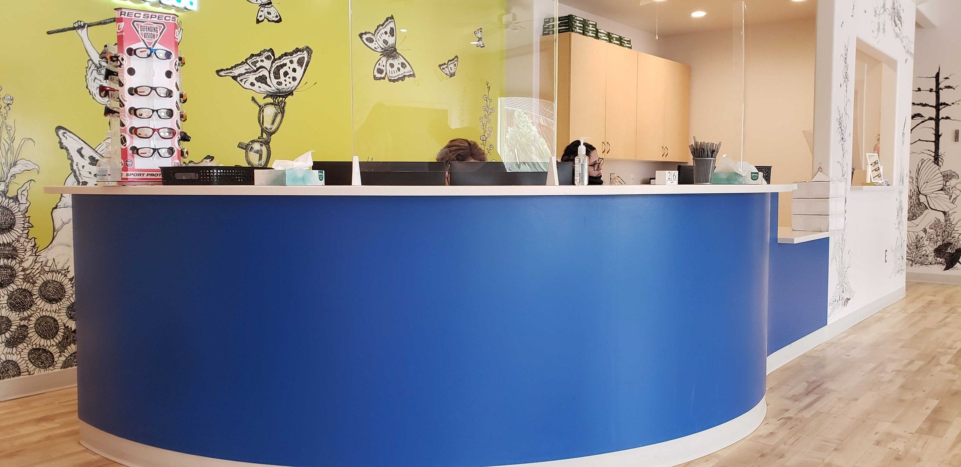 A large white counter in a room with a chandelier hanging from the ceiling.