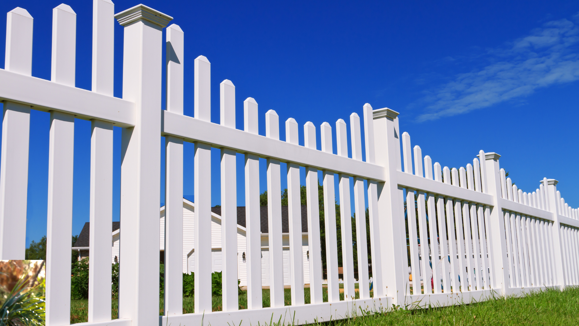 A white picket fence surrounds a lush green yard.