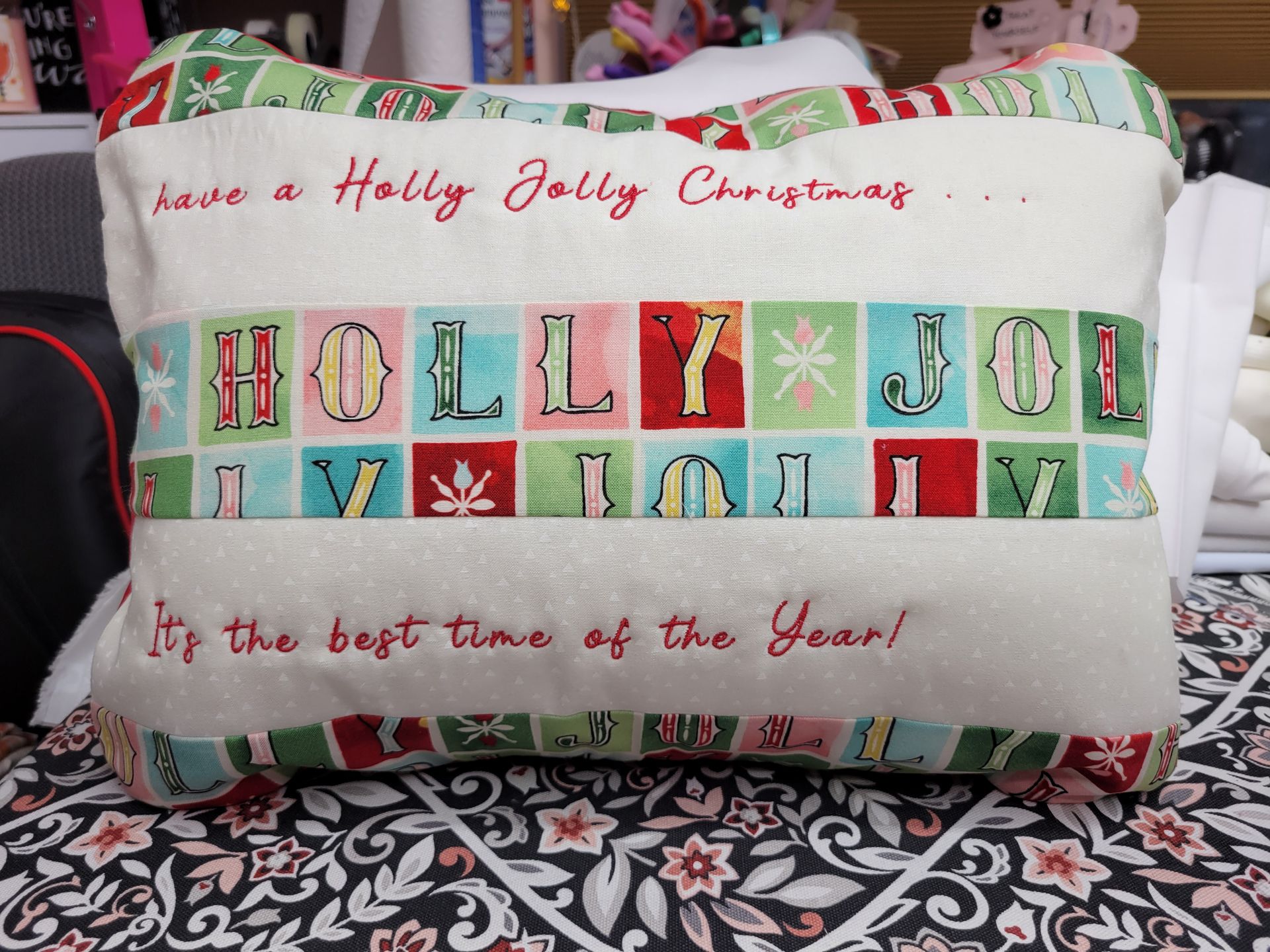 A pillow with holly jolly christmas written on it