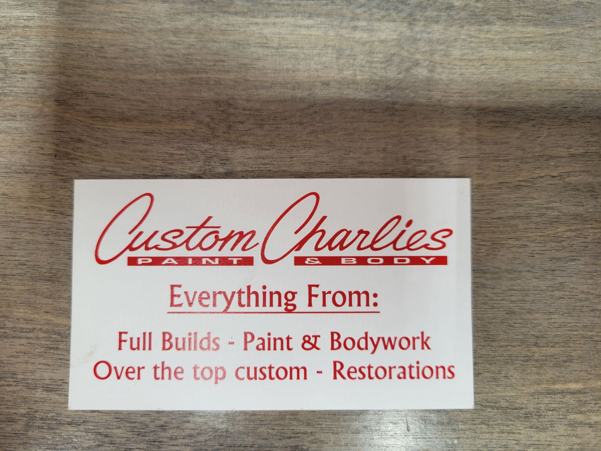 A business card for custom charlies paint and bodywork