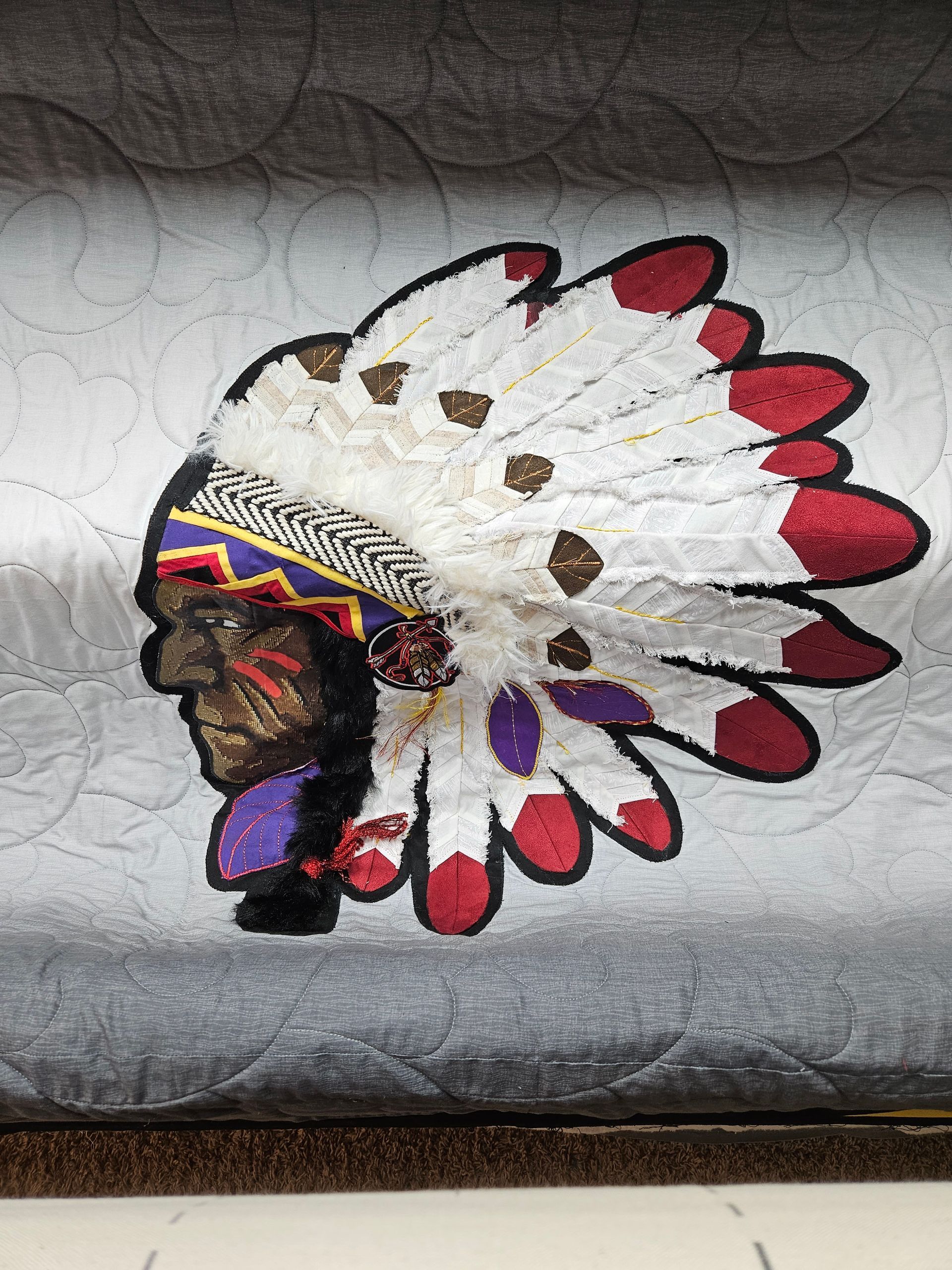 A painting of a native american with feathers on his head