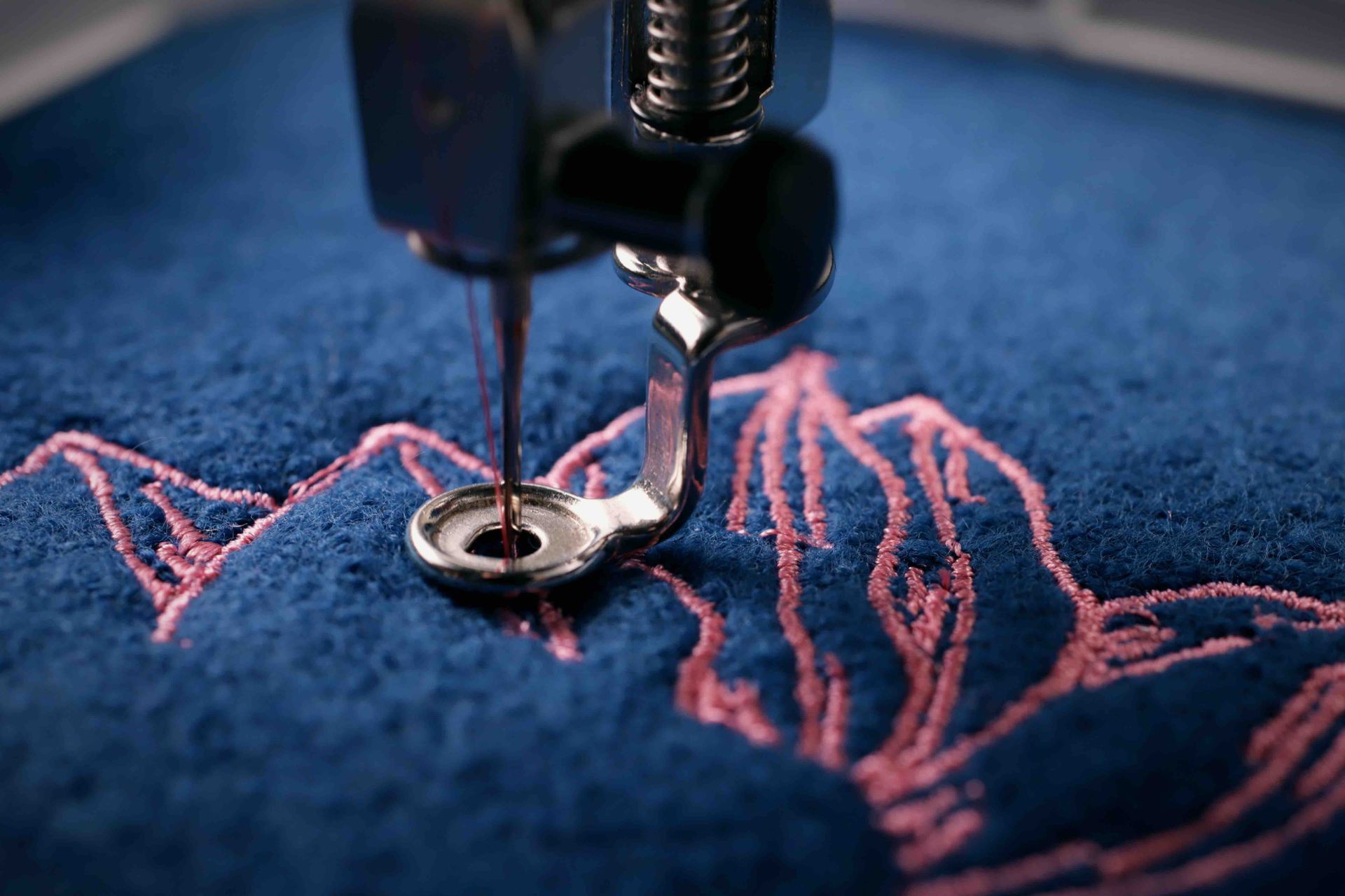 A close up of a sewing machine embroidery on a piece of fabric.