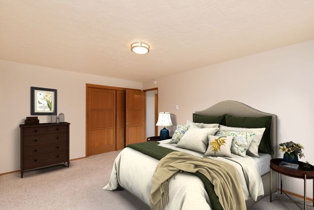 A bedroom with a bed , nightstand , dresser and window.