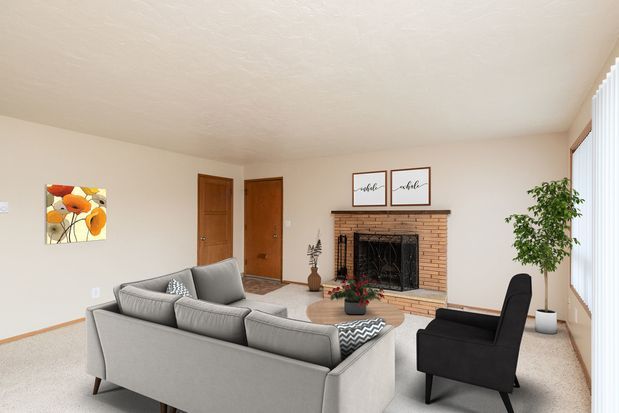 A living room with a couch , chair and coffee table