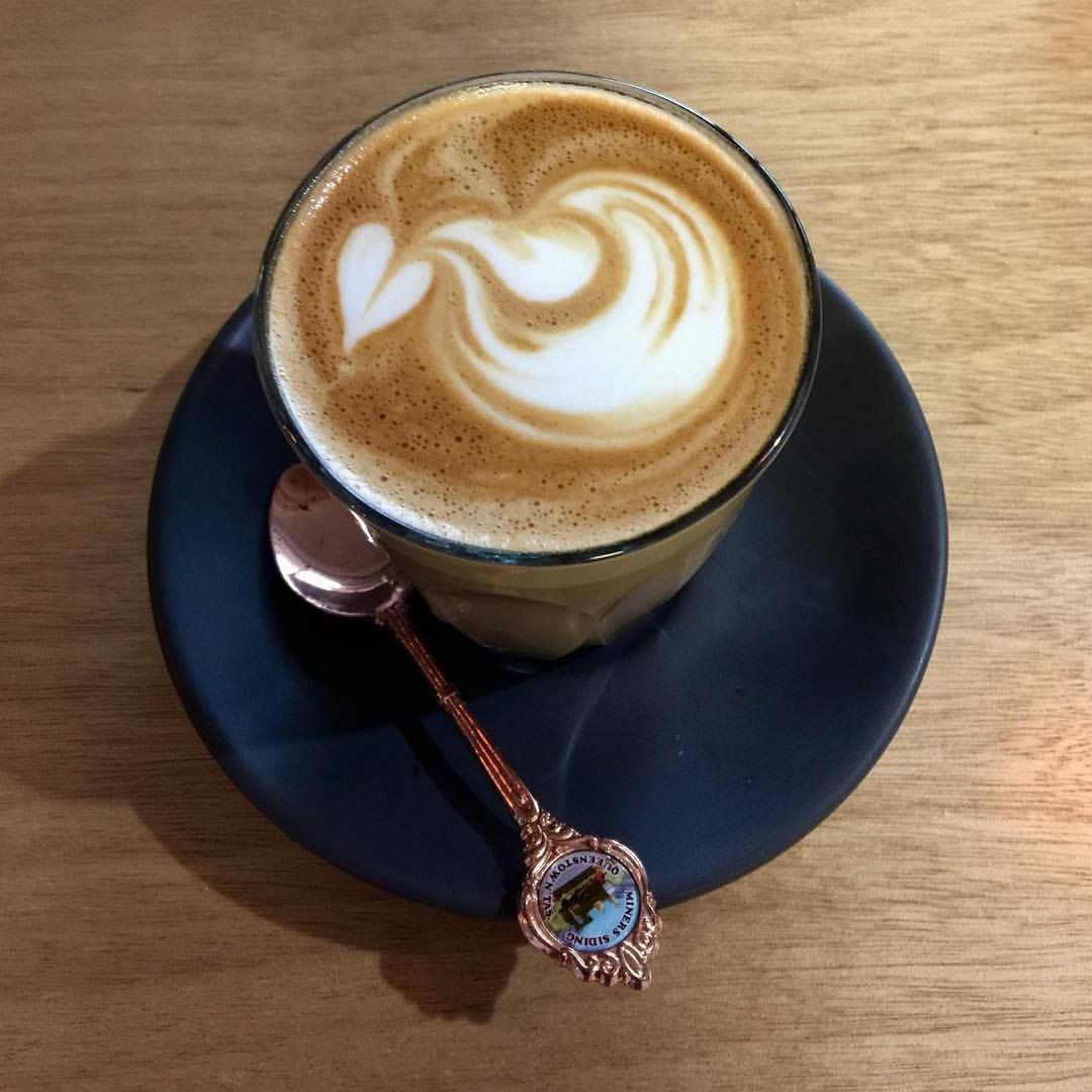 A Cup of Coffee on a Saucer With a Spoon — Memories Cafe At Yorkeys Knob