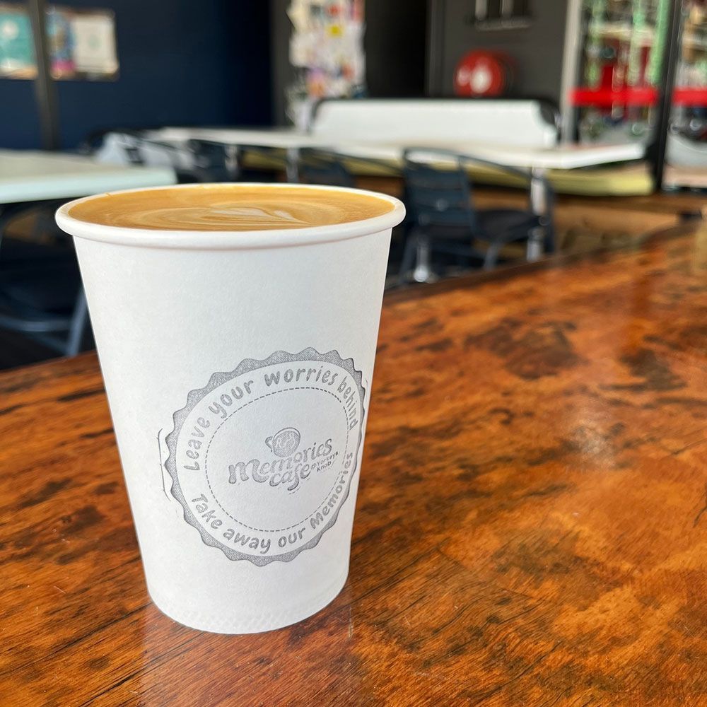 Memories Cafe Coffee is Sitting on a Wooden Table — Memories Cafe At Yorkeys Knob