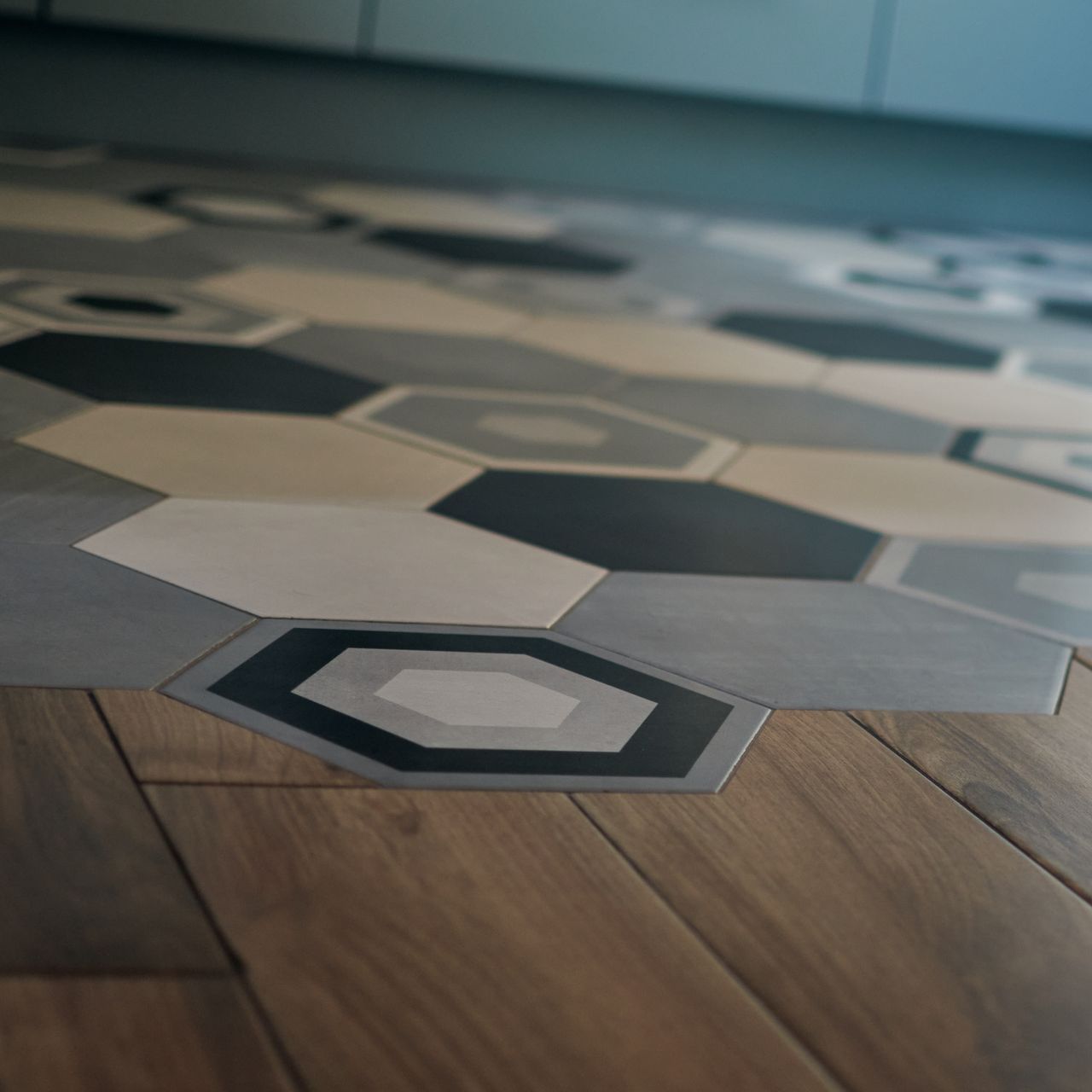 a wooden floor with hexagonal tiles on it