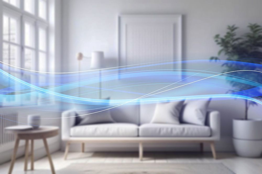 Living room with a white couch, small table, and plant, overlaid with blue, wavy lines.