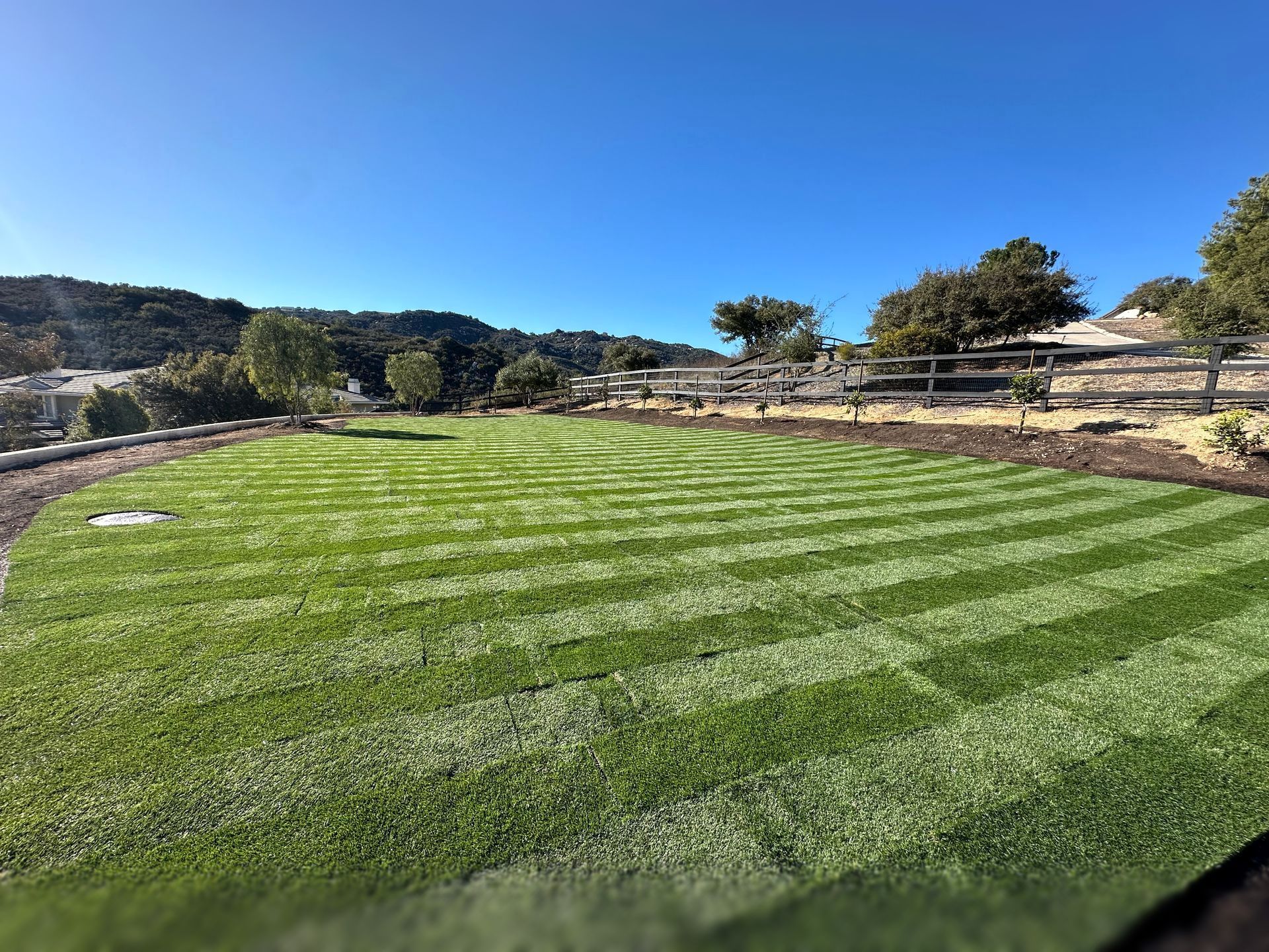 A house with a garage and a generator in front of it.
