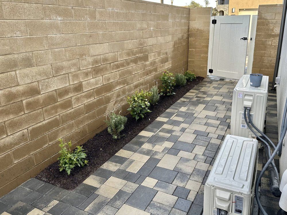 There are two air conditioners on the side of the walkway.