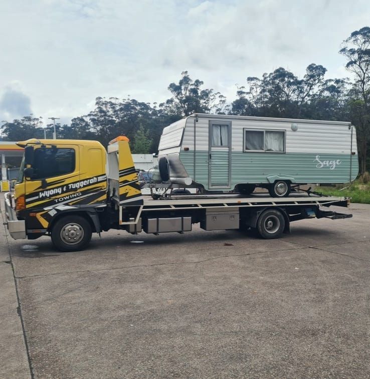 A Tow Truck is Carrying a Trailer That Says Sage — Wyong and Tuggerah Towing Service in Gosford, NSW