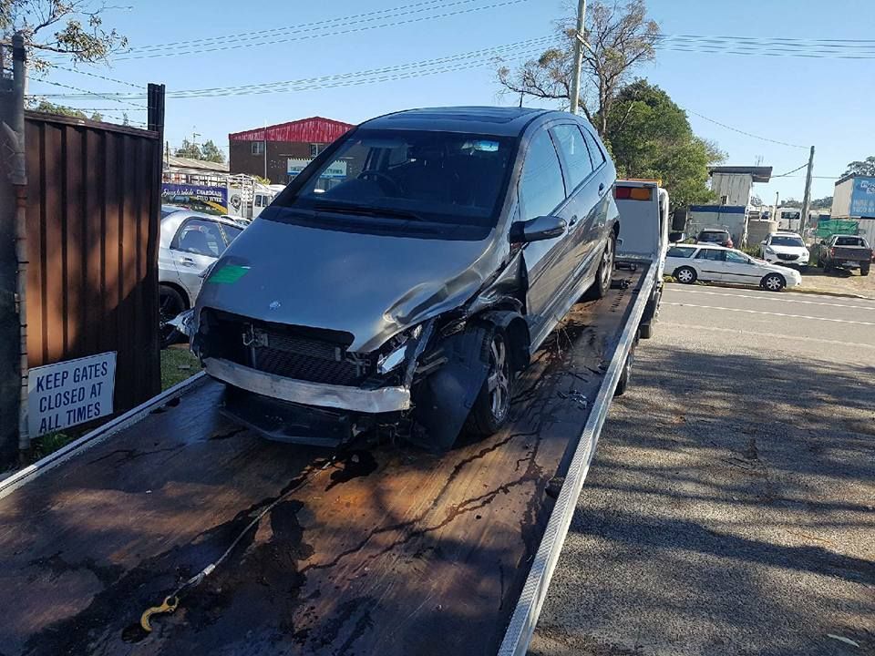 A Car is Sitting on Top of a Tow Truck — Wyong and Tuggerah Towing Service in Lake Haven, NSW
