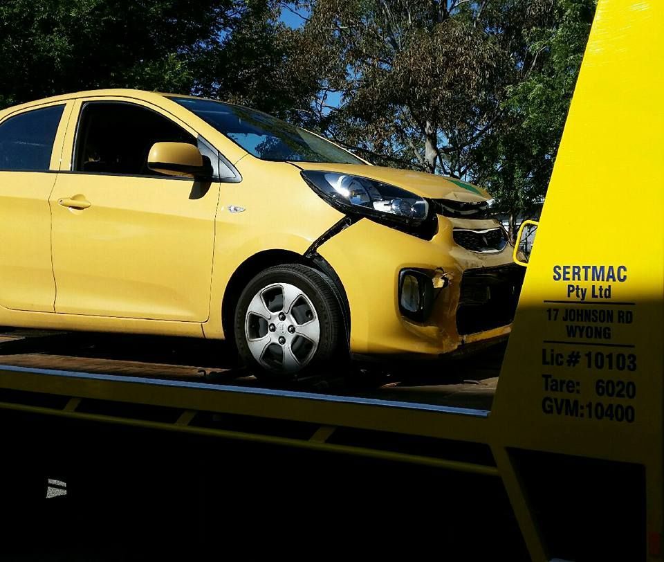 A Yellow Car is Sitting on Top of a Yellow Tow Truck — Wyong and Tuggerah Towing Service in Lake Haven, NSW