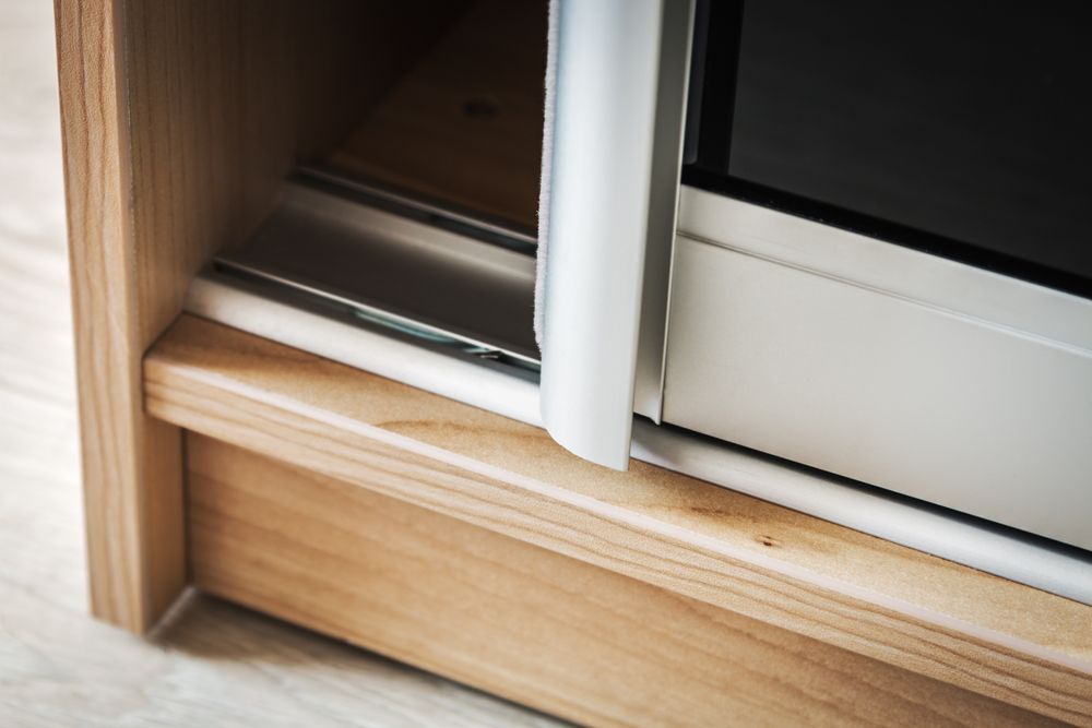 Close-up of a Wooden-framed Sliding Door, Showing the Track, Rail, and Door Edge — Sams Glass Solutions in Proserpine, QLD