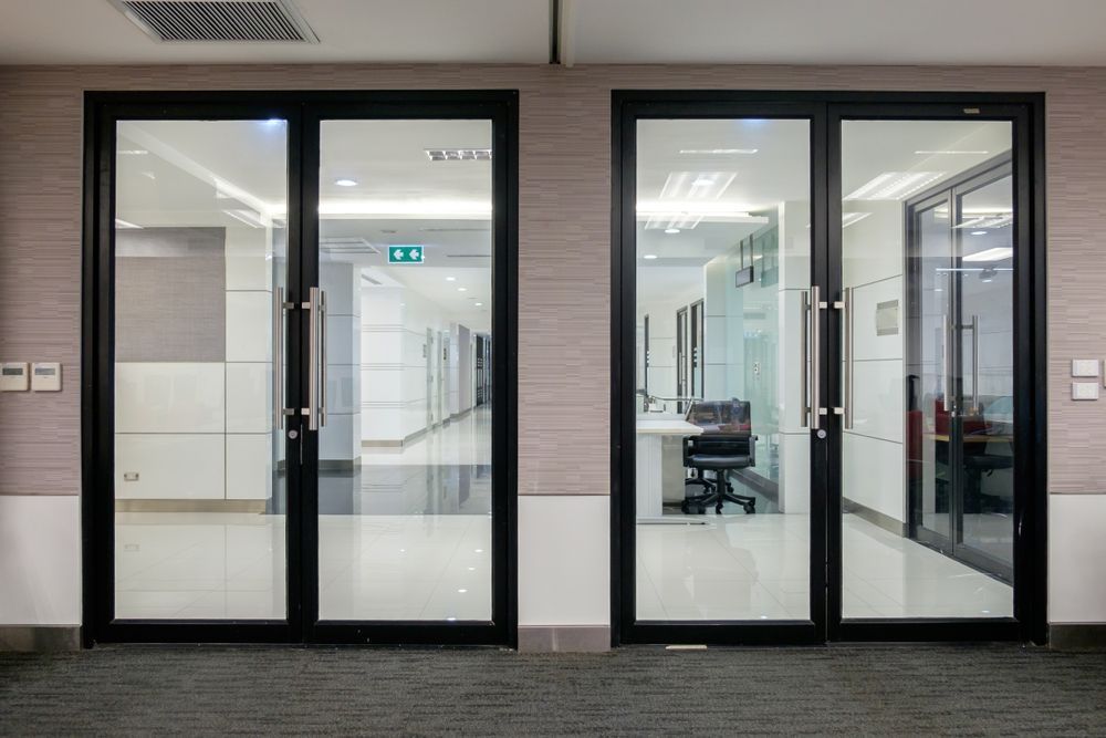 Two Glass Doors With Black Frames in an Office Hallway — Sams Glass Solutions in Airlie Beach, QLD