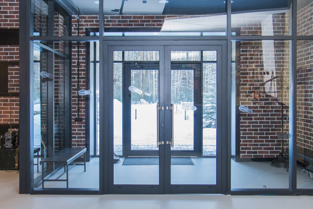 A Set of Dark-framed Glass Double Doors Leading to a Snowy Exterior — Sams Glass Solutions in Proserpine, QLD