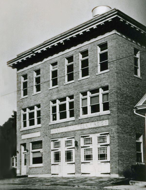 Black and white photo of older fire house.