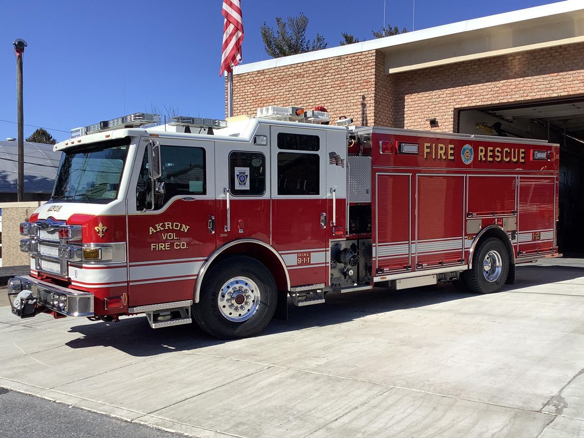Akron's Rescue Engine 12-1  parked in front of the fire station.