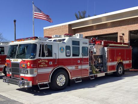 Akron's Rescue Engine 12-2  parked in front of the fire station.