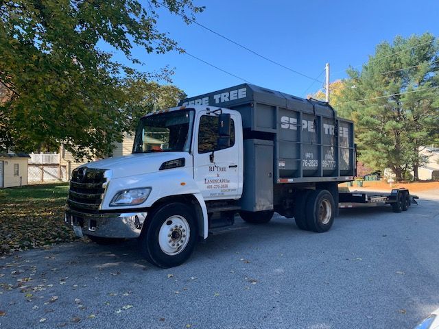A dump truck is parked on the side of the road.