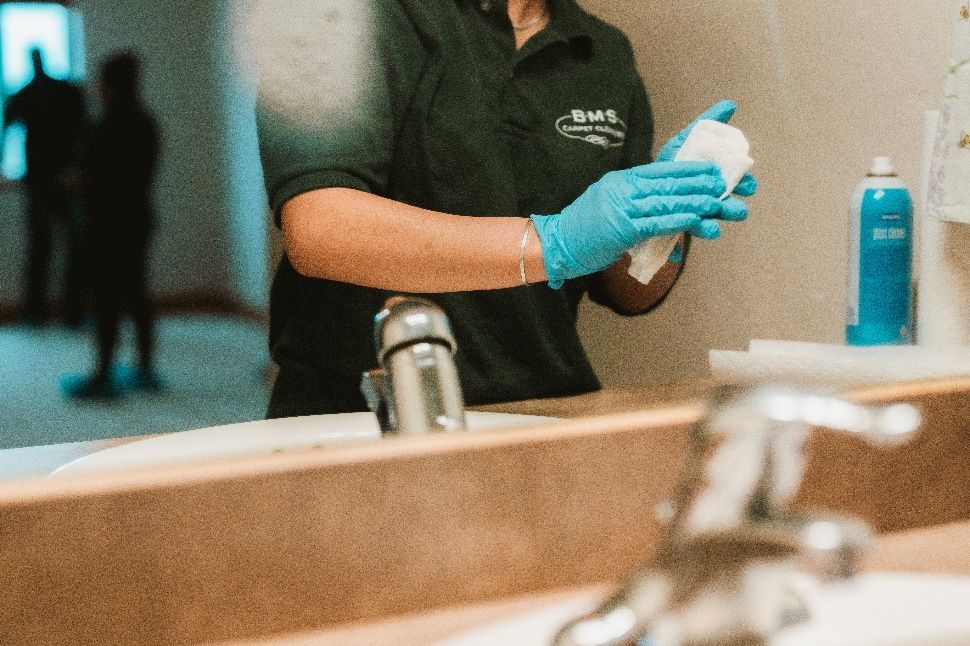 The picture shows a technician cleaning the sink