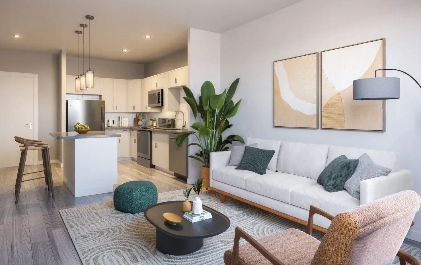 Open-concept living area with sofa, kitchen island, and greenery in a modern apartment.