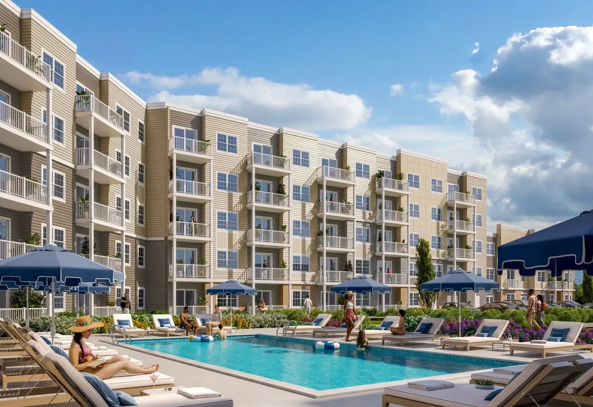 Pool deck at a modern apartment complex with lounge chairs and blue umbrellas.