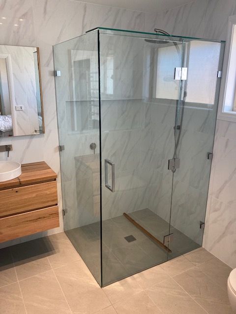 A Bathroom With a Walk in Shower and a Bathtub — Patterson Glass Works in Kempsey, NSW