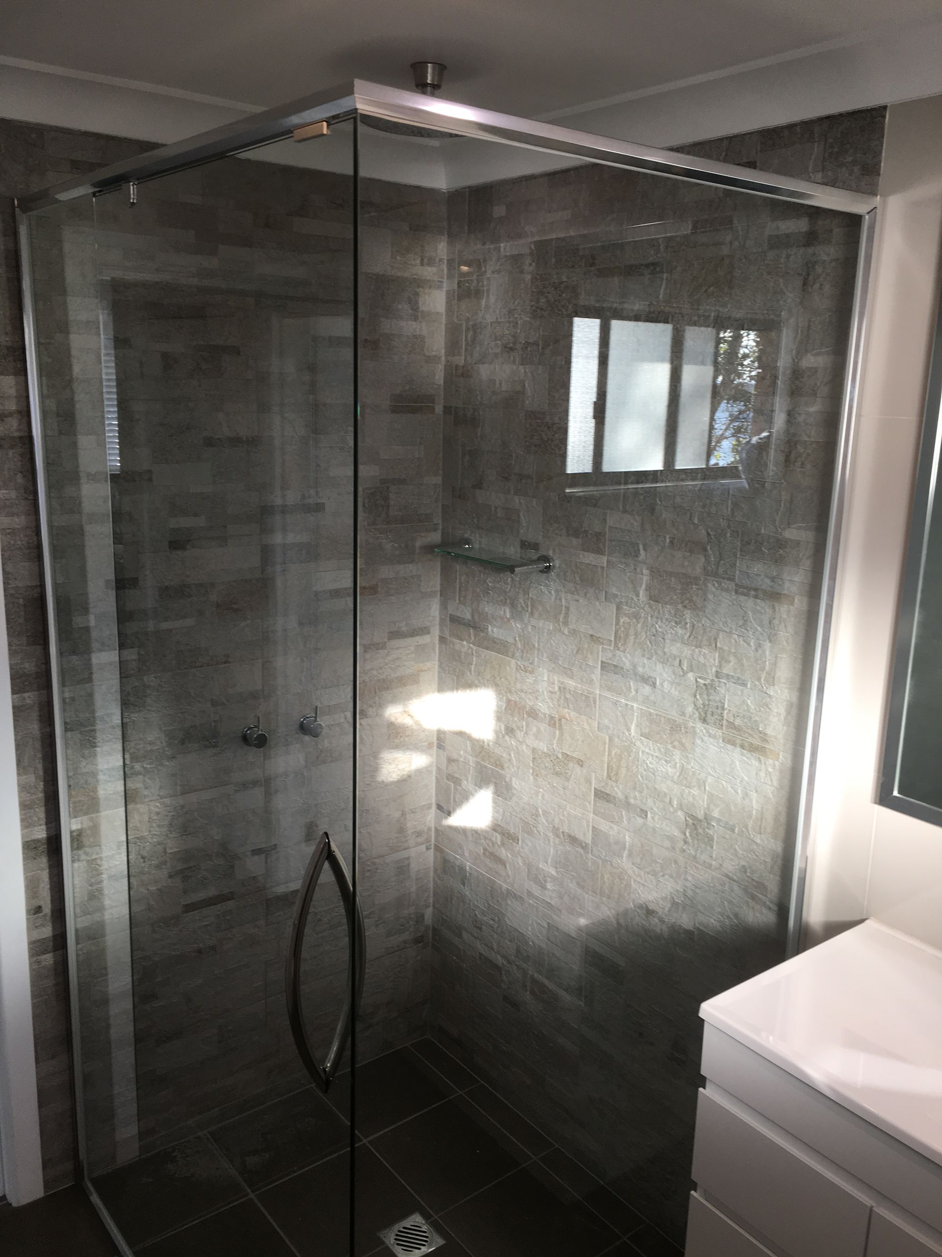 A Bathroom With a Walk in Shower and a Bathtub — Patterson Glass Works in Kempsey, NSW