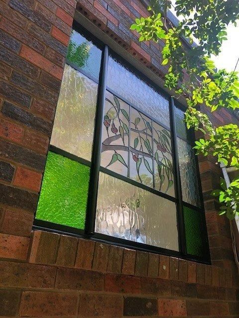 A Brick Building With a Stained Glass Window — Patterson Glass Works in Kempsey, NSW